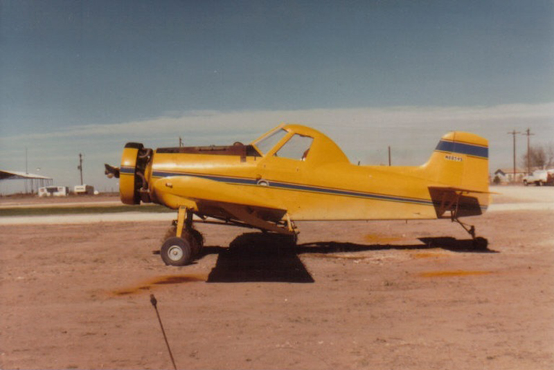 Air Tractor agricultural aircraft, model AT-301, parked on a dirt runway, showcasing its robust design and capabilities for crop dusting and aerial application.