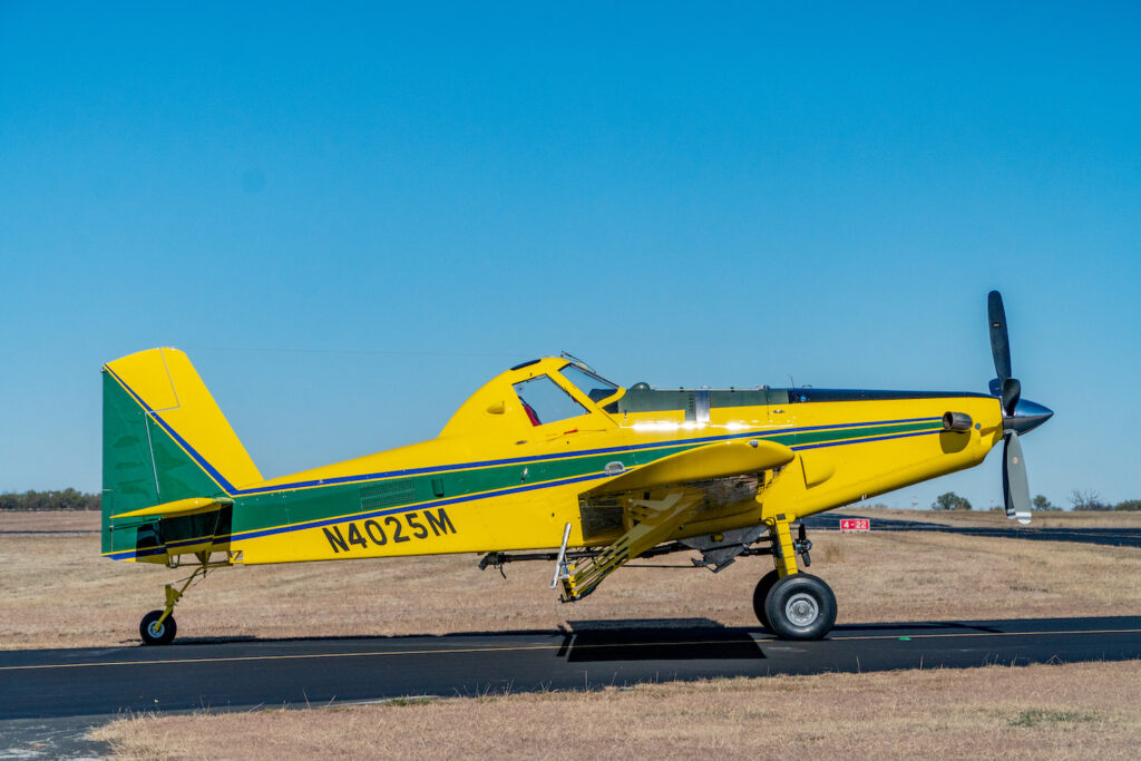 Air Tractor AT-502B agricultural aircraft on the runway, showcasing its robust design and versatile capabilities for crop dusting and aerial application.