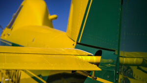 Close-up view of the tail and wing of an Air Tractor agricultural aircraft, highlighting its robust design and precision engineering, ideal for aerial application in farming.