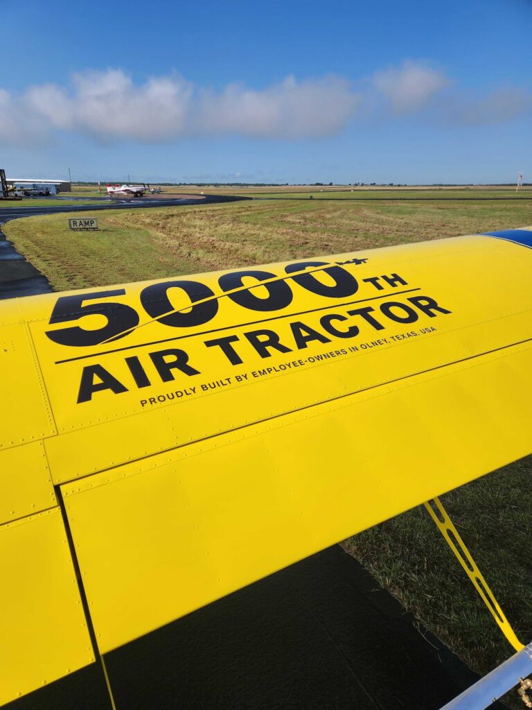 5000th Air Tractor aircraft, showcasing the company's commitment to excellence in agricultural aviation. This employee-owned model represents a significant milestone in the production of Air Tractor planes, known for their reliability and efficiency in crop dusting and agricultural applications.