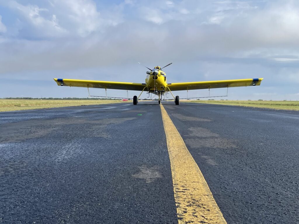 Air Tractor AT-502B agricultural aircraft on a runway, designed for aerial application and crop dusting, showcasing its robust build and performance capabilities.