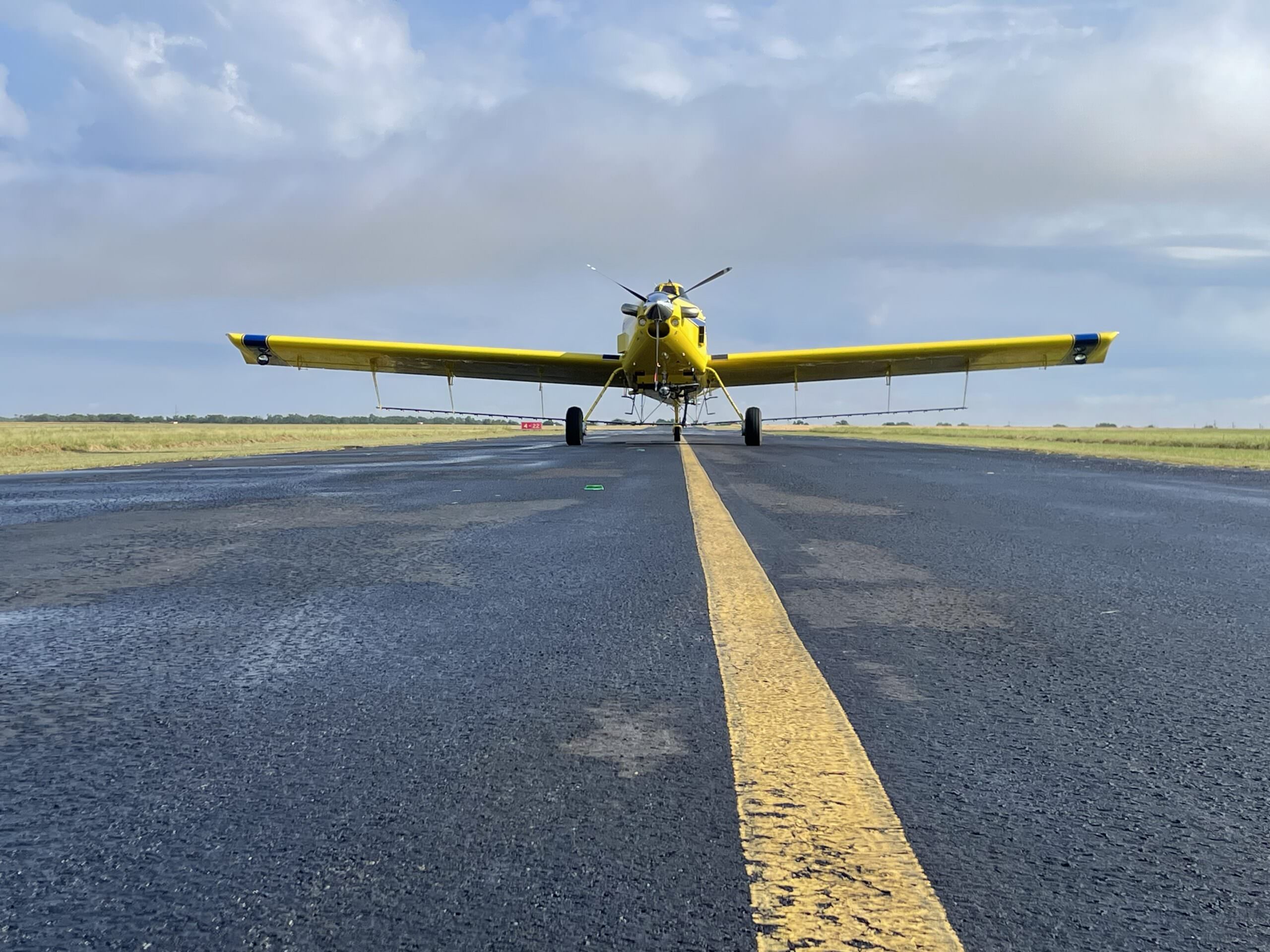 Air Tractor AT-502B agricultural aircraft on a runway, designed for aerial application and crop dusting, showcasing its robust build and performance capabilities.